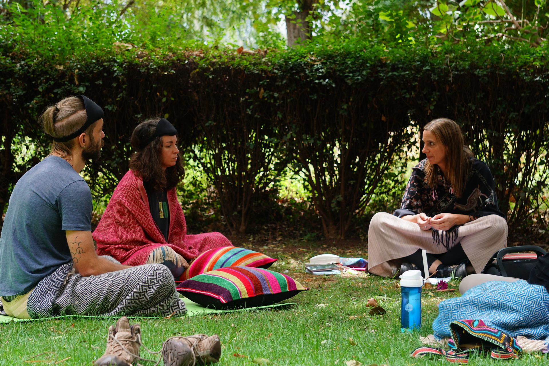 Students listen to a teacher in the garden
