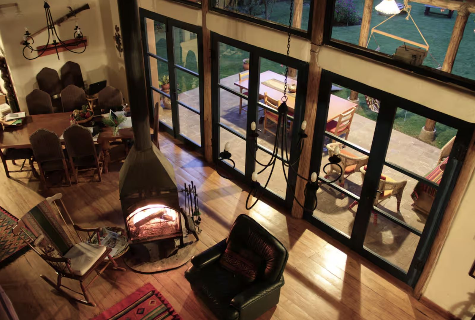 Evening by the wood stove, with the dining room and the garden beyond the windows